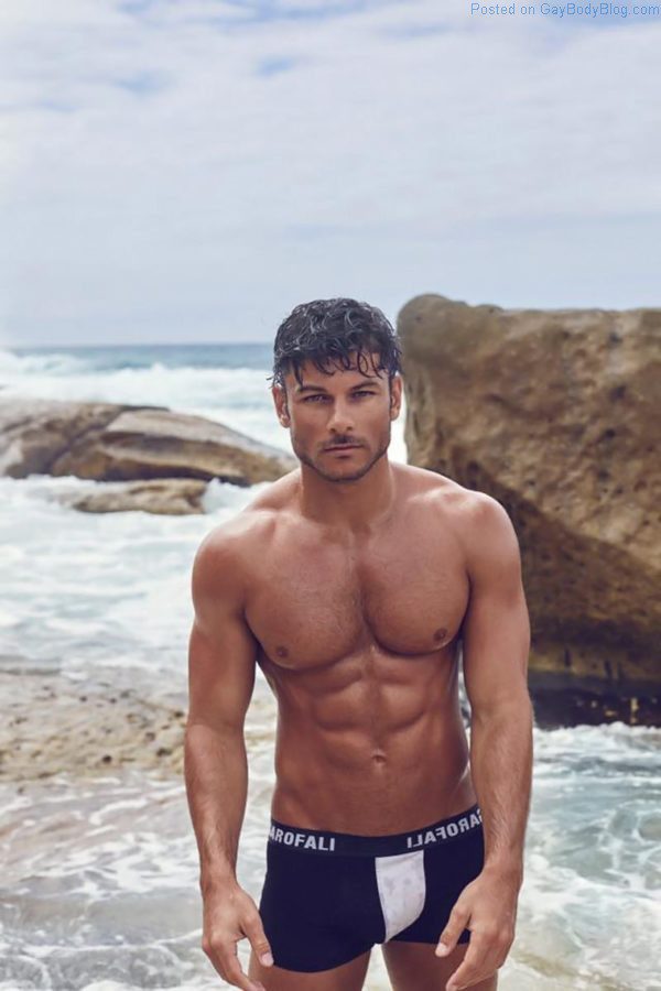 Male model Daniel Garofali at the beach wet and showing his Australian jock bulge