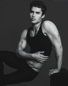 Black and white image of male model Brandon Lipchik sitting