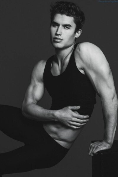 Black and white image of male model Brandon Lipchik sitting