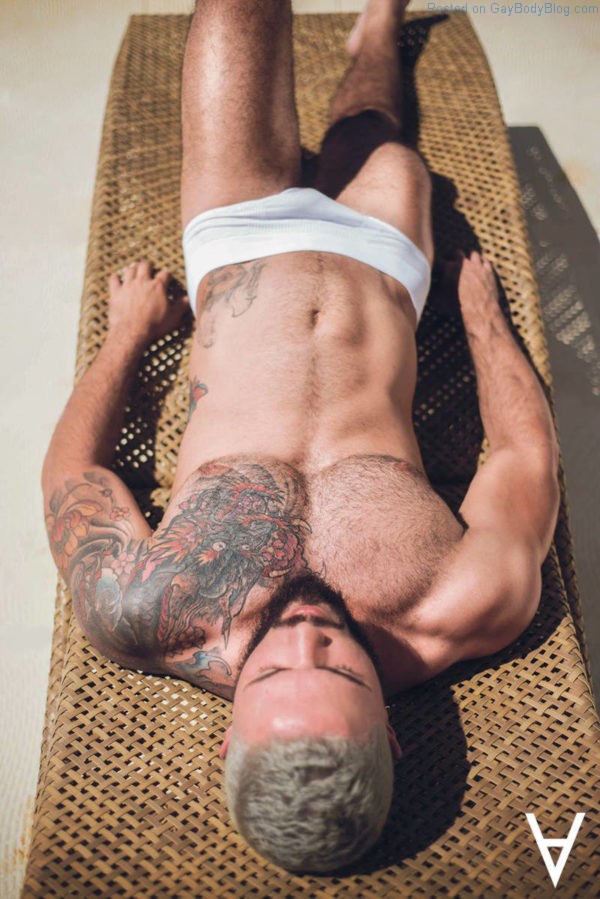 Muscled model Adriano Cardoso sunbathing