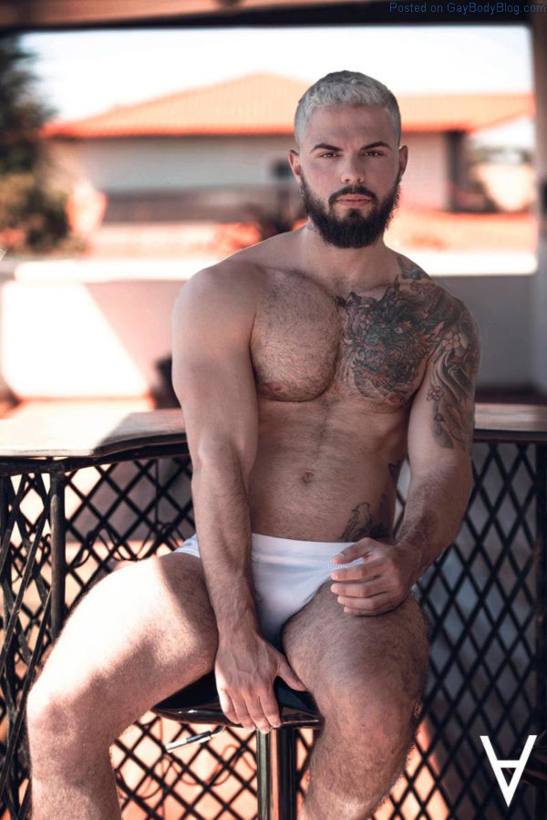 Male model Adriano Cardoso sitting in the shade in white underwear