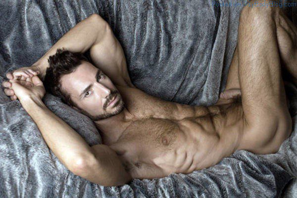 Hairy daddy model Bryan Slater laying on a couch naked