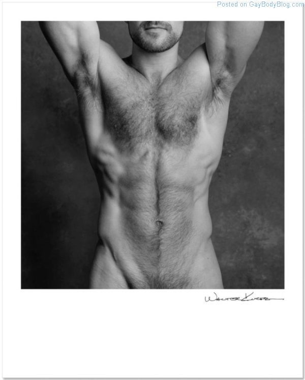 Shirtless male model with a hairy chest in black and white