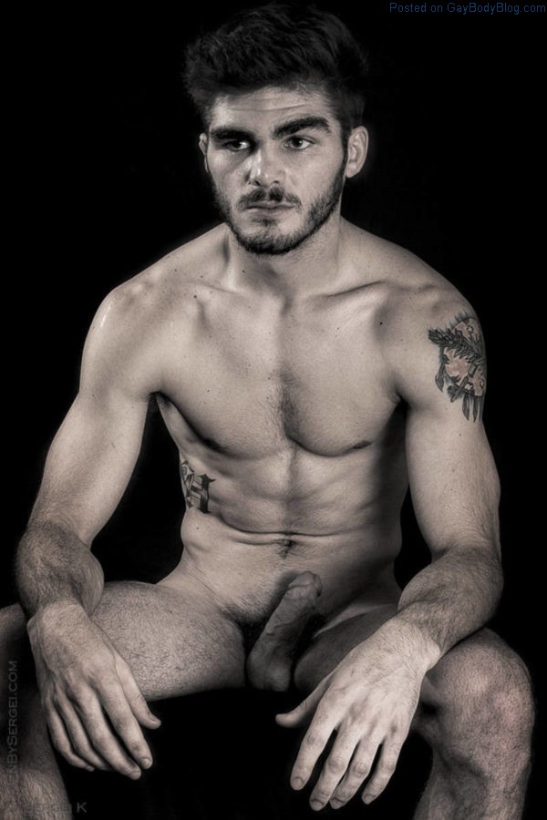 naked male model sitting with a hard cock