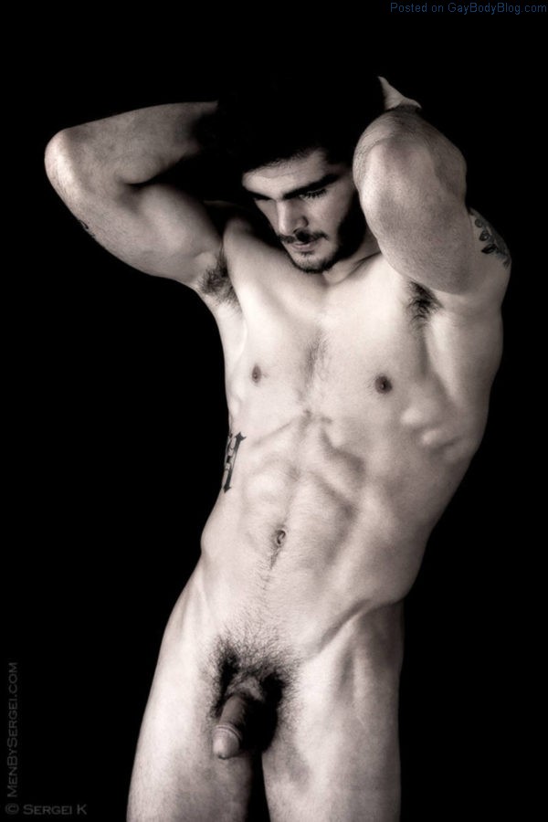 nude male model standing with a soft cock