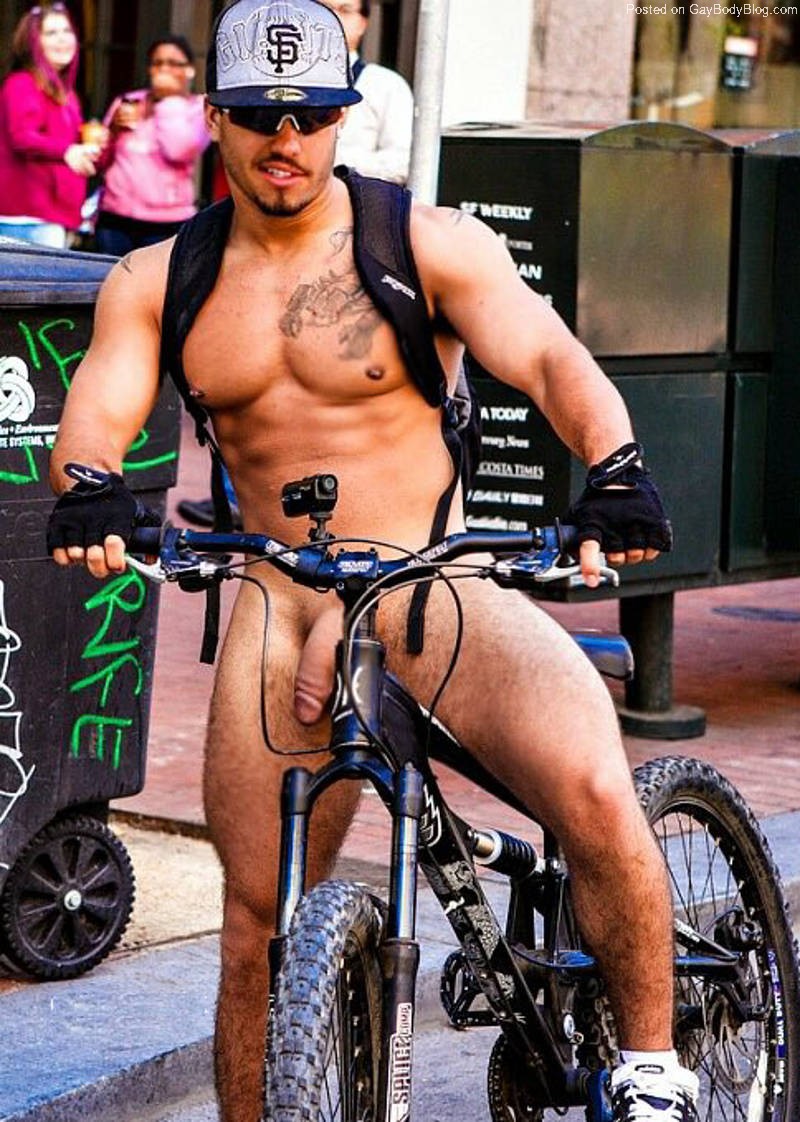 hung guy showing dick while riding a bike