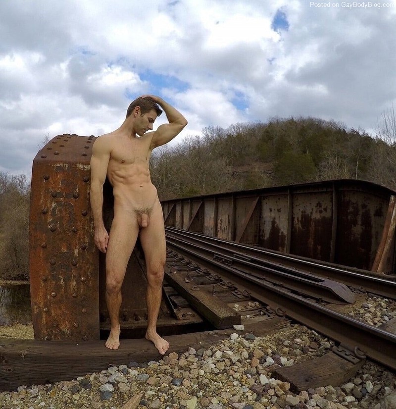 Self-shot nude photographer Jacob Dillon poses on a bridge