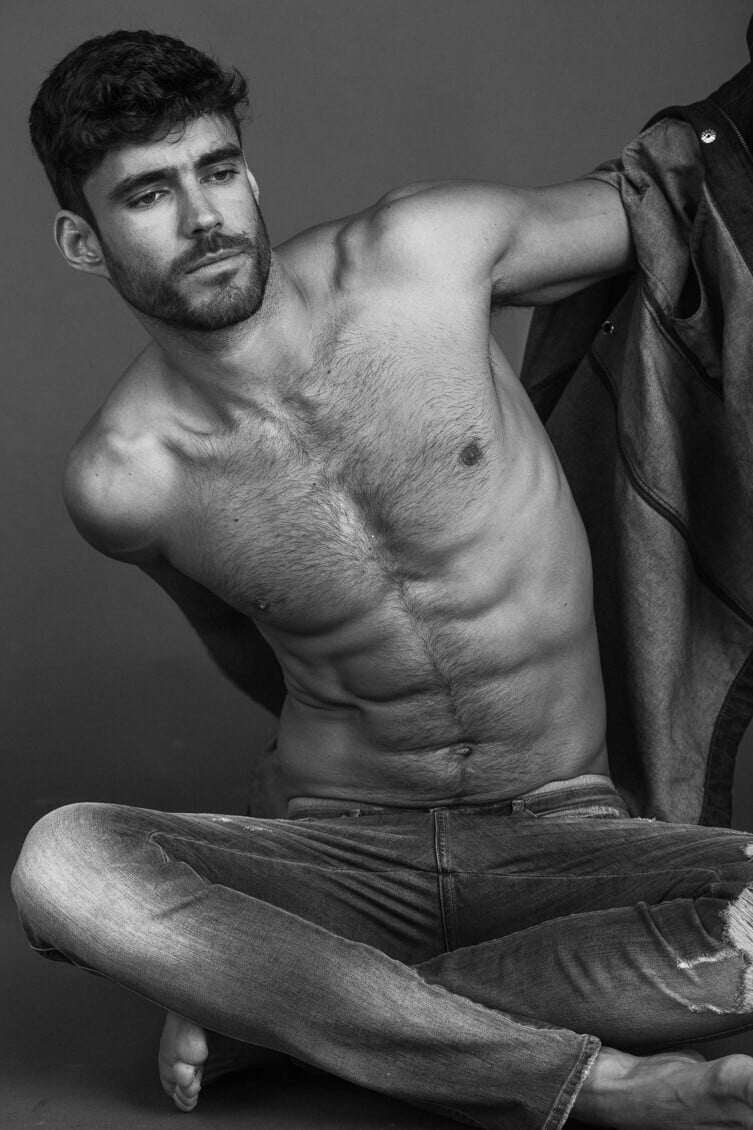 gorgeous male model Caio Cesar taking his shirt off to reveal his fine physique and hairy chest