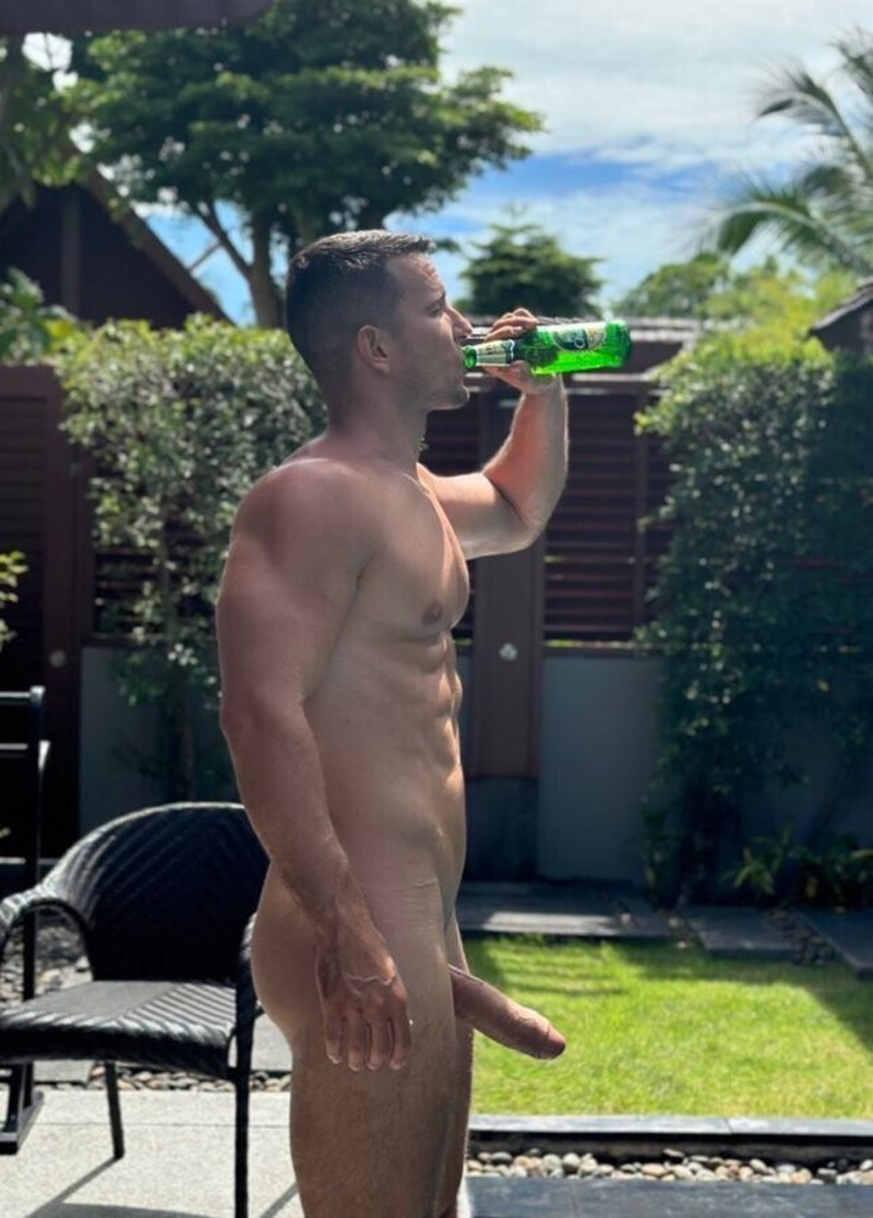 Jakub Stefano takes a sip from a bottle while his huge uncut penis juts out in front of him